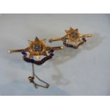 WITHDRAWN:TWO 15ct Gold and Blue Enamelled Military 'East Yorkshire Regiment' Brooches