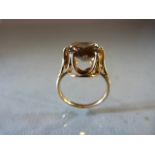 9ct Gold ring with high setting supporting a large Citrine