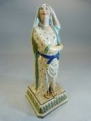 Staffordshire pearlware figure on a goddess type lady with one arm raised on head. Dressing in a