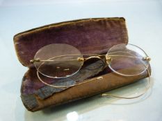 Pair of frame less spectacles with gold coloured wire arms in metal case (A/F)