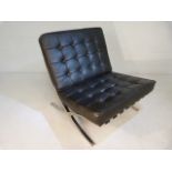 Barcelona style chair upholstered in black leather on chrome base.