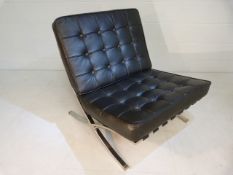 Barcelona style chair upholstered in black leather on chrome base.