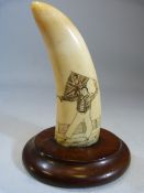 Scrimshaw whales tooth depicting a man holding a british flag over his head. Mounted on a mahogany