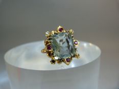 Antique Gold Metal (possible foreign Gold) ornate ring with large central stone supported by Ruby