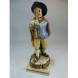 Staffordshire pearlware figure of a young boy dressed in overcoat and black hat emblematic of
