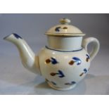 Miniature Creamware Pratt Teapot and cover. Decorated with blue and ochre in the form of flowers