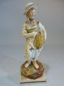Enamel painted pearlware figure poss Neale of an Agricultural working lady stood on Pratt coloured