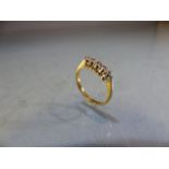 18ct GOLD five diamond ring size J.5