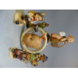 Selection of Goebel Hummel figures along with a Circular wall plaque depicting a baby looking at a