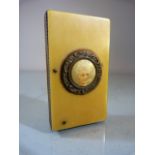 Mid-Century Bone and celluloid Vesta case. Striker to side. Small circular panel depicting a lady to