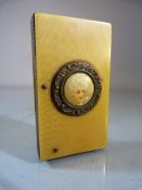 Mid-Century Bone and celluloid Vesta case. Striker to side. Small circular panel depicting a lady to