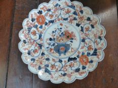 19th Century Japanese Imari plate with handpainted central panel of flowers in an urn.