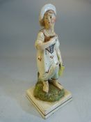 Staffordshire pearlware 19th century figure of a lady collecting flowers mounted on square base.