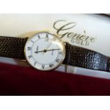 A 9ct gents Geneve wrist watch with date dial in presentation case