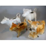 Four Jersey cow creamers - 2 blanc de chine, swiss and a Guernsey example.