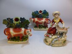 Pair of staffordshire cow spill vases on square bases stood infront of a tree. Along with an unusual