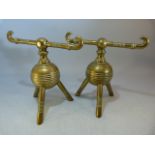 A Pair of Christopher Dresser Brass Globular Fire Dogs on Tripod Feet, both stamped 11 to base