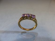 9ct Gold ring set with three Amethyst stones. Size M