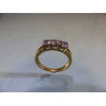 9ct Gold ring set with three Amethyst stones. Size M