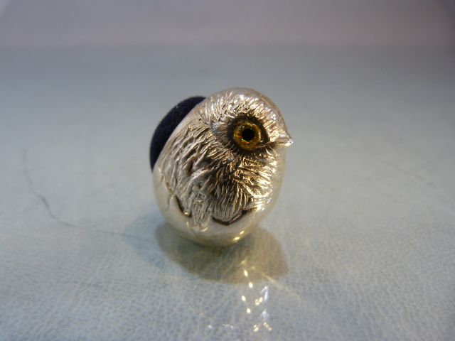 Silver pin cushion in the form of a chick with glass eyes