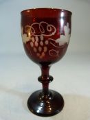 Antique cranberry wine glass of small form with Wheel cut decoration