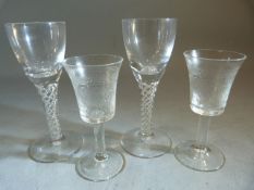 Pair of Georgian Wine glasses with double twisted air stems on domed base along with two etched
