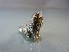 A cast silver figure of a cat with Emerald eyes