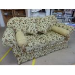 Floral upholstered beige ground three seater sofa