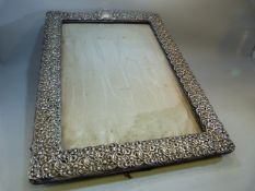 AN EDWARD VII SILVER PHOTOGRAPH FRAME of ornate foliate stamped design, large size approx 34cm x