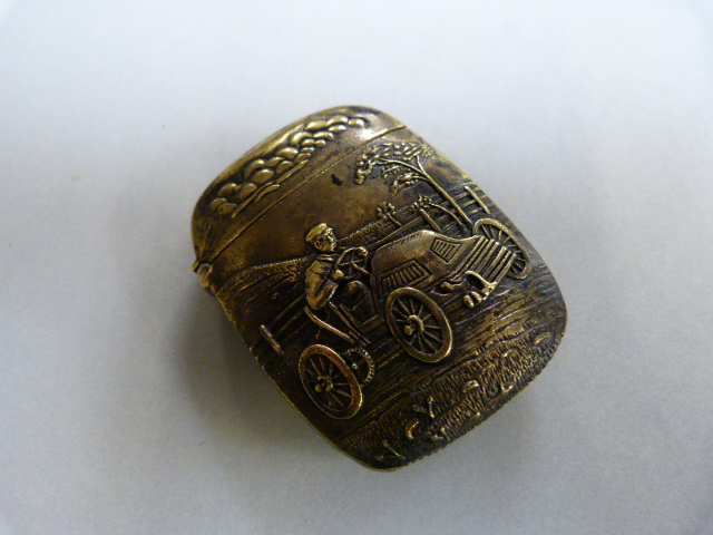 Brass cased Vesta with embossed decoration depicting a vintage automobile