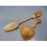 Antique carved medicine spoon and one other with long stem leading to a floral pierced top.