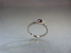 18ct white gold ladies ring with central Sapphire surrounded by diamond cluster