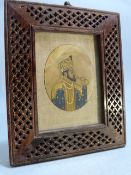 19th Century Mughal Ivory miniature mounted in a pierced work wooden frame.