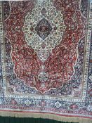Large red ground carpet with all over design 350 x 270