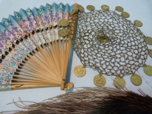 Selection of Ostrich Dress feathers, fan and a Middle Eastern headdress adorned with coins on a gold - Image 10 of 10