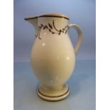 18th Century Staffordshire creamware jug of tall form. Brown banding to rim and foot. With simple
