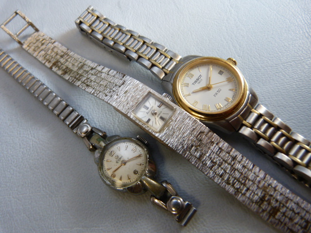 Three ladies silver coloured metal wrist watches. Two dress watches A/F by Accurist & CYMA and a