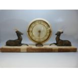 Art Deco mantle clock with circular face flanked by two recumbent bronzed deer.