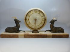 Art Deco mantle clock with circular face flanked by two recumbent bronzed deer.
