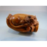Carved wooden Netsuke of a hand holding a 'lion'