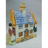 Early 19th Century Pratt Polychrome decorated money box in the form of a house, modelled with a