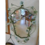 Modern wall mirror with vine leaves and flowers surrounding