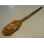 Carved wooden African oar of short form.