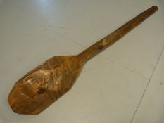 Carved wooden African oar of short form.