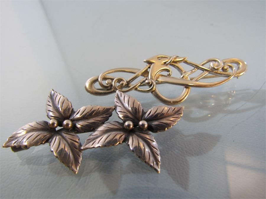 Two silver brooches - 1) Marked DENMARK JOHN L Sterling on the 'C' clasp this double leaf flower