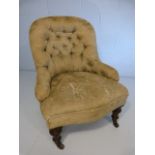 Button back nursing chair on turned wooden legs