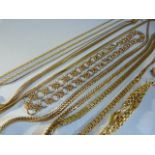 Collection of gold coloured necklaces of various styles and a gold coloured brooch.