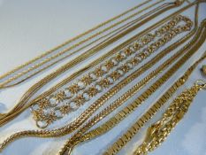 Collection of gold coloured necklaces of various styles and a gold coloured brooch.