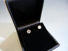 Pair of 14ct white gold diamond stud earrings of approx 1.1pts