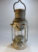 Metal ships lamp with brass label 'Anchor'